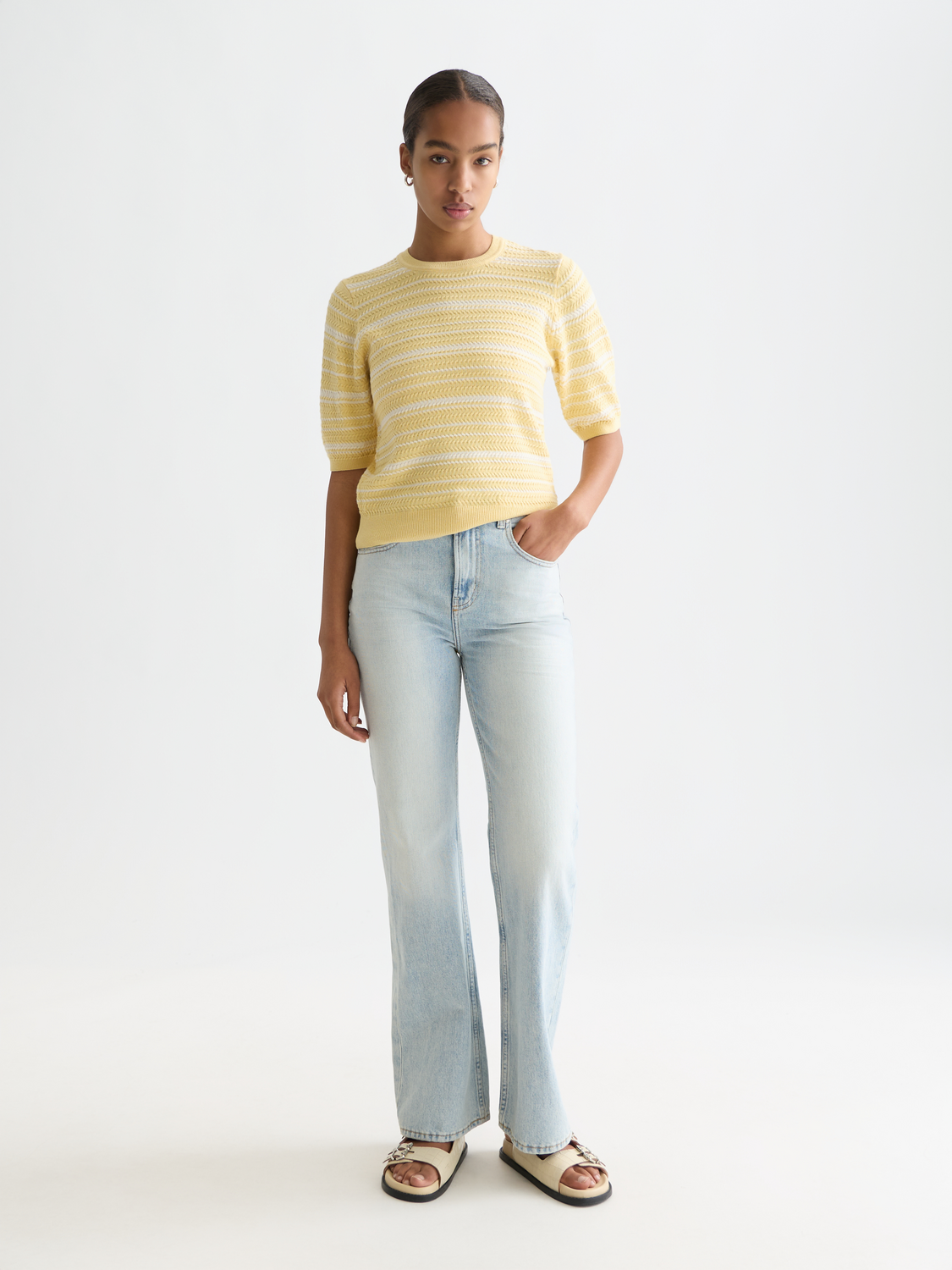 Striped knitted t-shirt by Scotch & Soda featuring a classic knitwear design with colorful horizontal stripes.