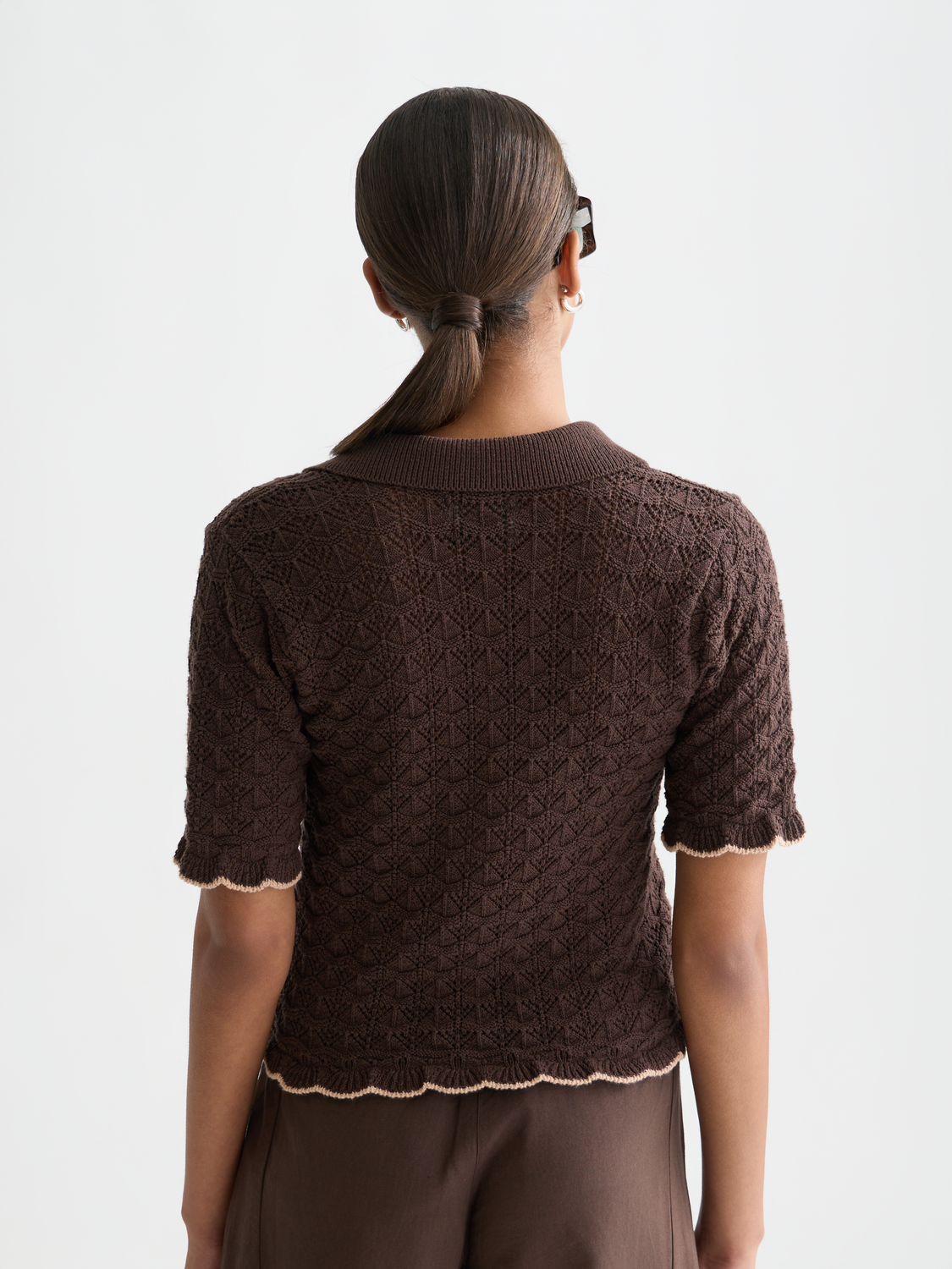 Pointelle short-sleeved knitwear cardigan by Scotch & Soda displayed from the back, showing delicate knit pattern and relaxed fit.