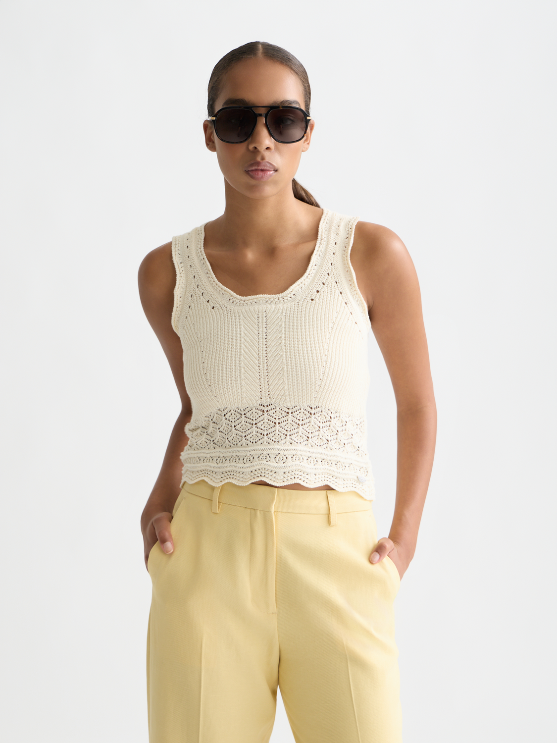 Pointelle knitted tank vest by Scotch & Soda, featuring a delicate openwork pattern and sleeveless design in neutral tones.