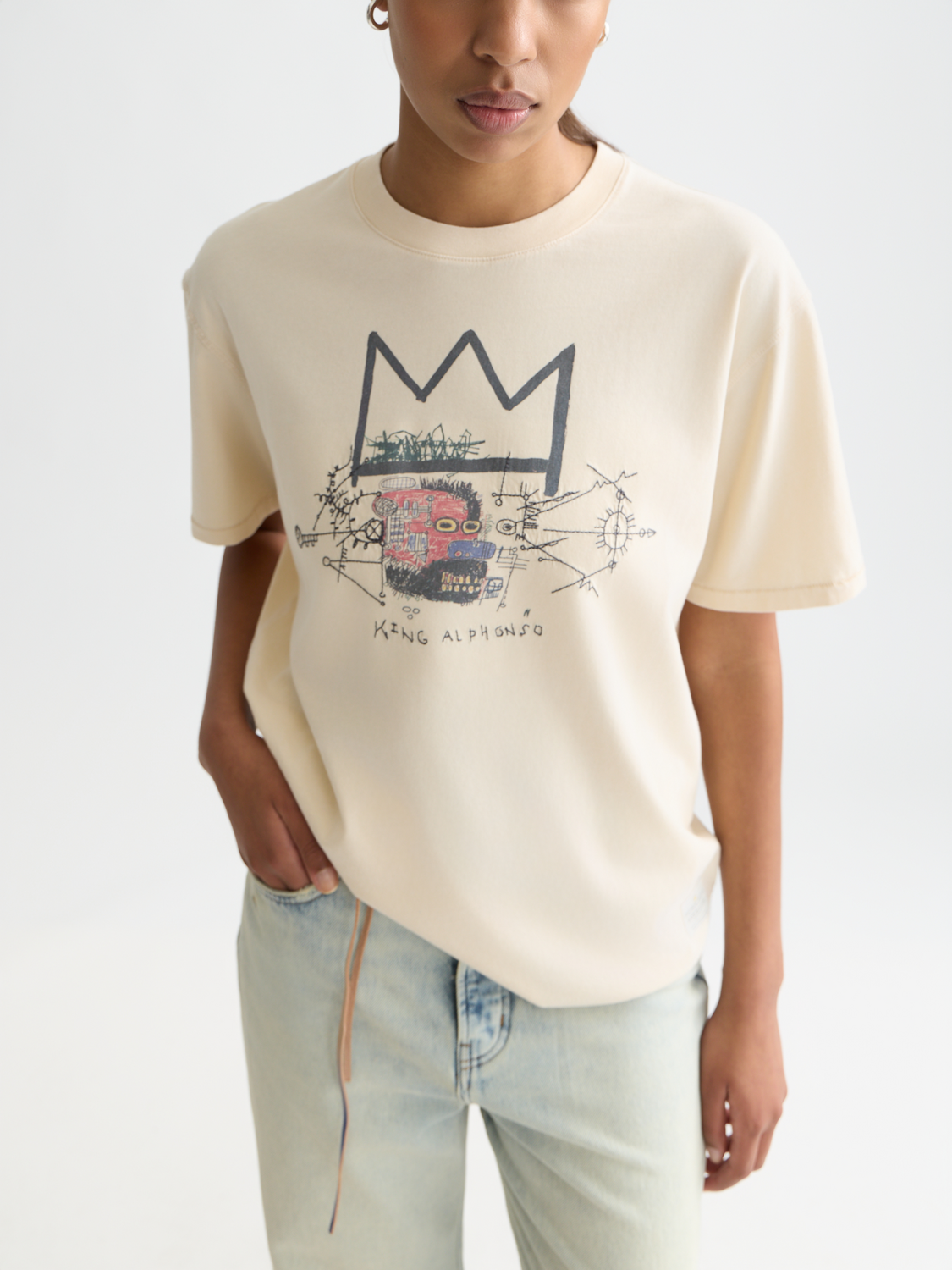 Short sleeve SCOTCH & SODA t-shirt featuring washed artwork by Basquiat, with a vibrant graphic design on the front.