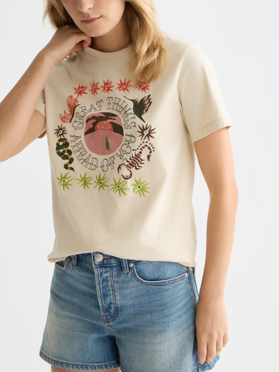 Blue short-sleeve Scotch & Soda embroidered artwork T-shirt with colorful floral design on front.