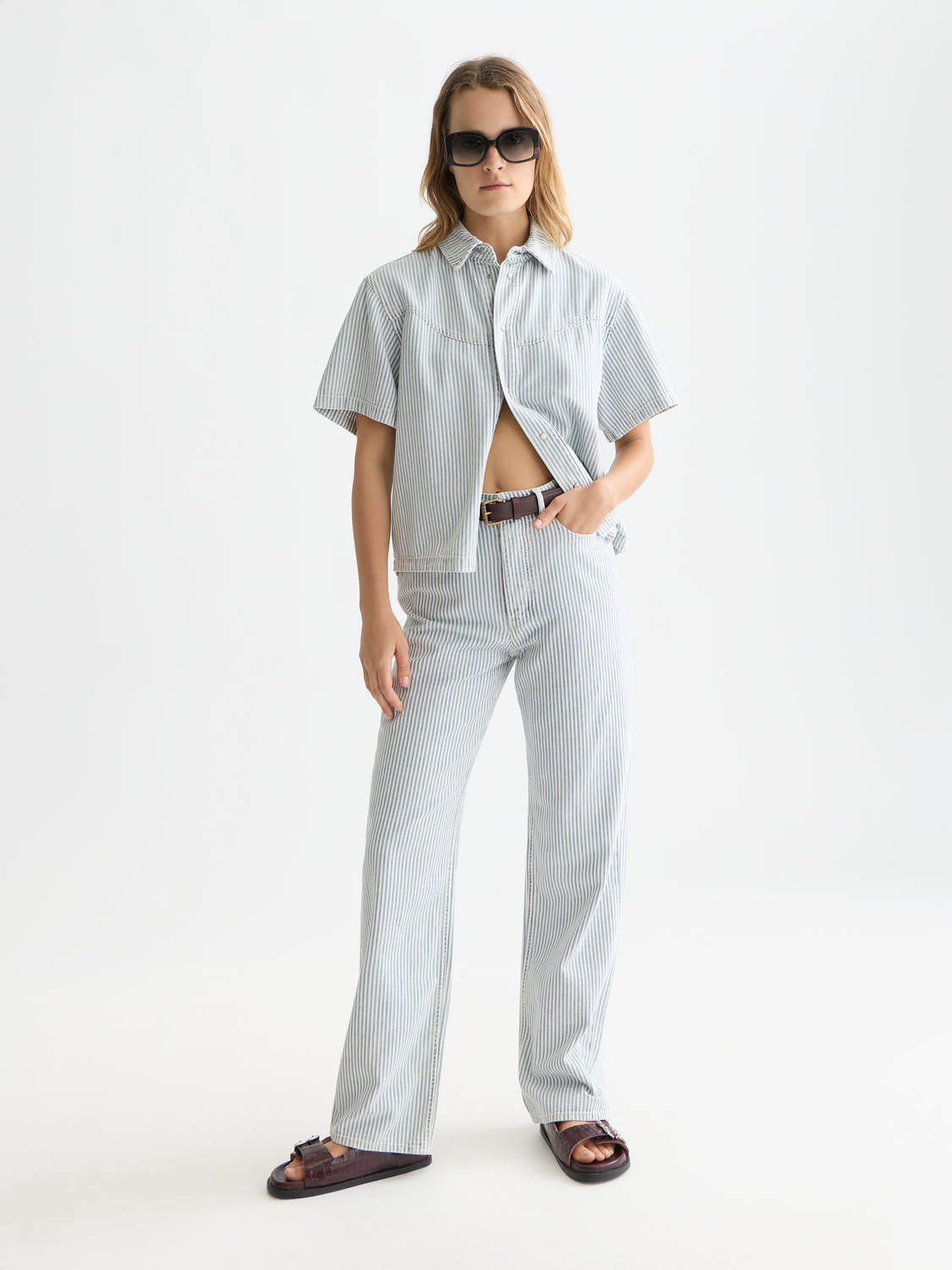 Short-sleeved denim shirt by Scotch & Soda, featuring classic button-up design and chest pockets in a light blue denim fabric.