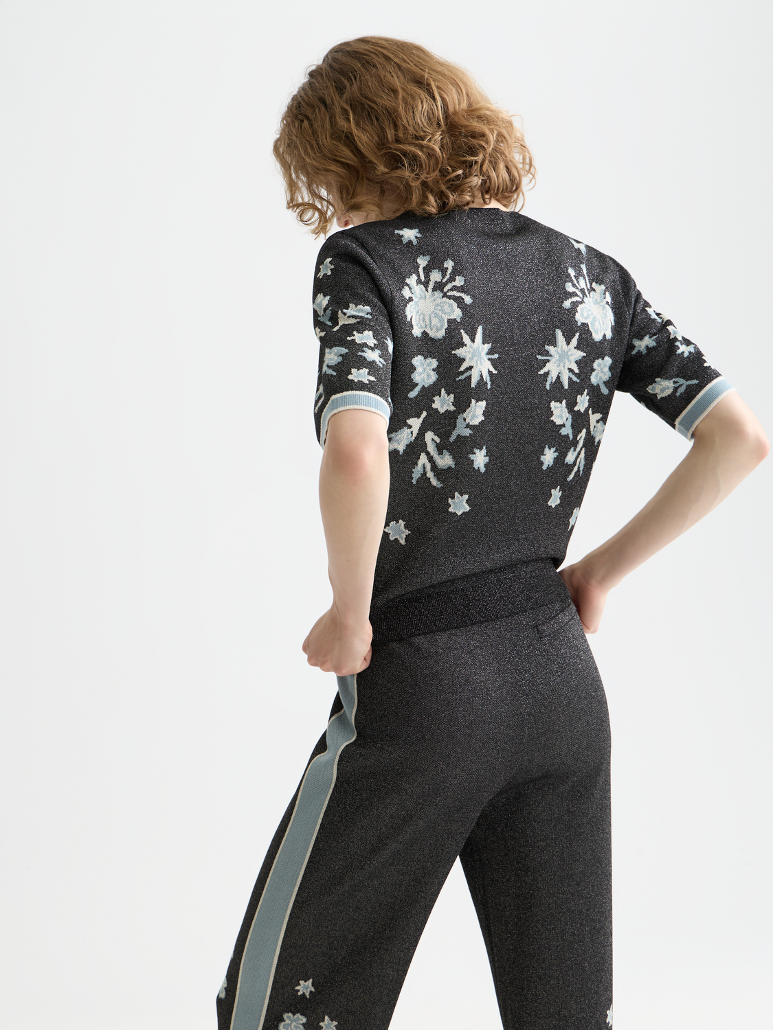Black jacquard short-sleeved knit top by Scotch & Soda, featuring intricate pattern and a relaxed fit.