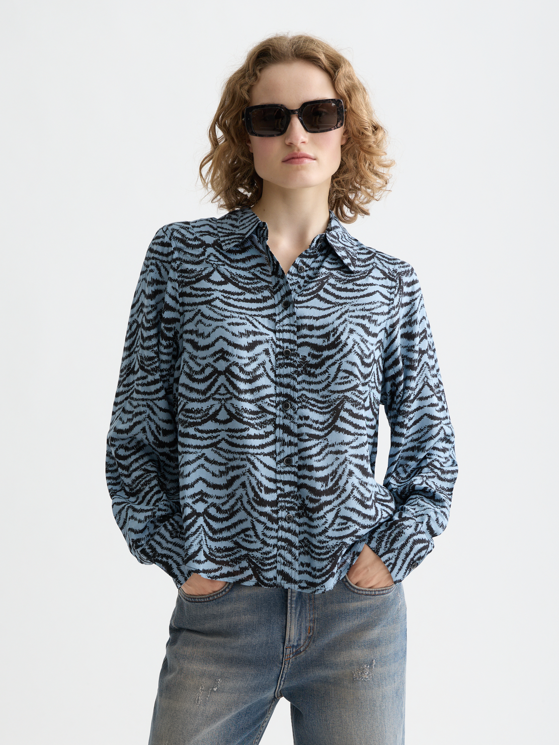 Long sleeve printed shirt by Scotch & Soda, featuring vibrant patterns and a casual fit, shown on a model.
