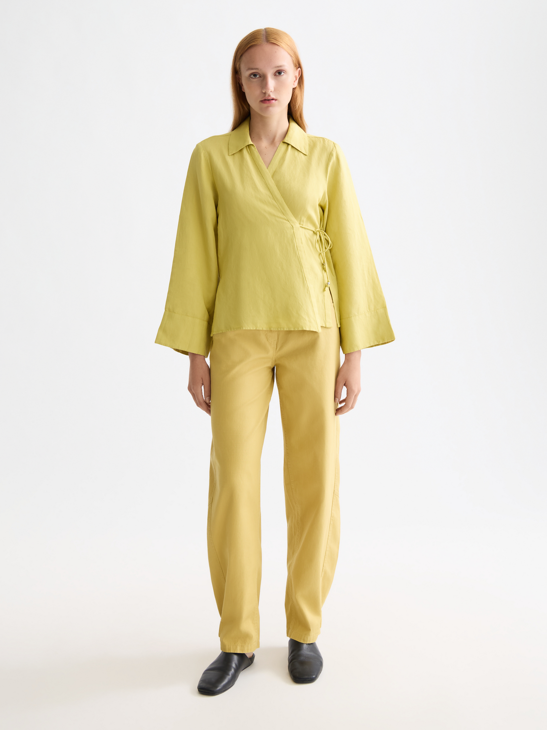 Long sleeve wrap shirt by Scotch & Soda featuring a stylish design and button details, displayed on a neutral background.