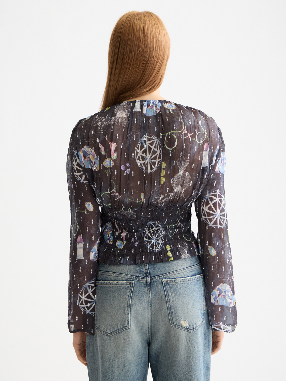 Woven top by Scotch & Soda with smocked waist, featuring a relaxed fit and long sleeves, shown in black.