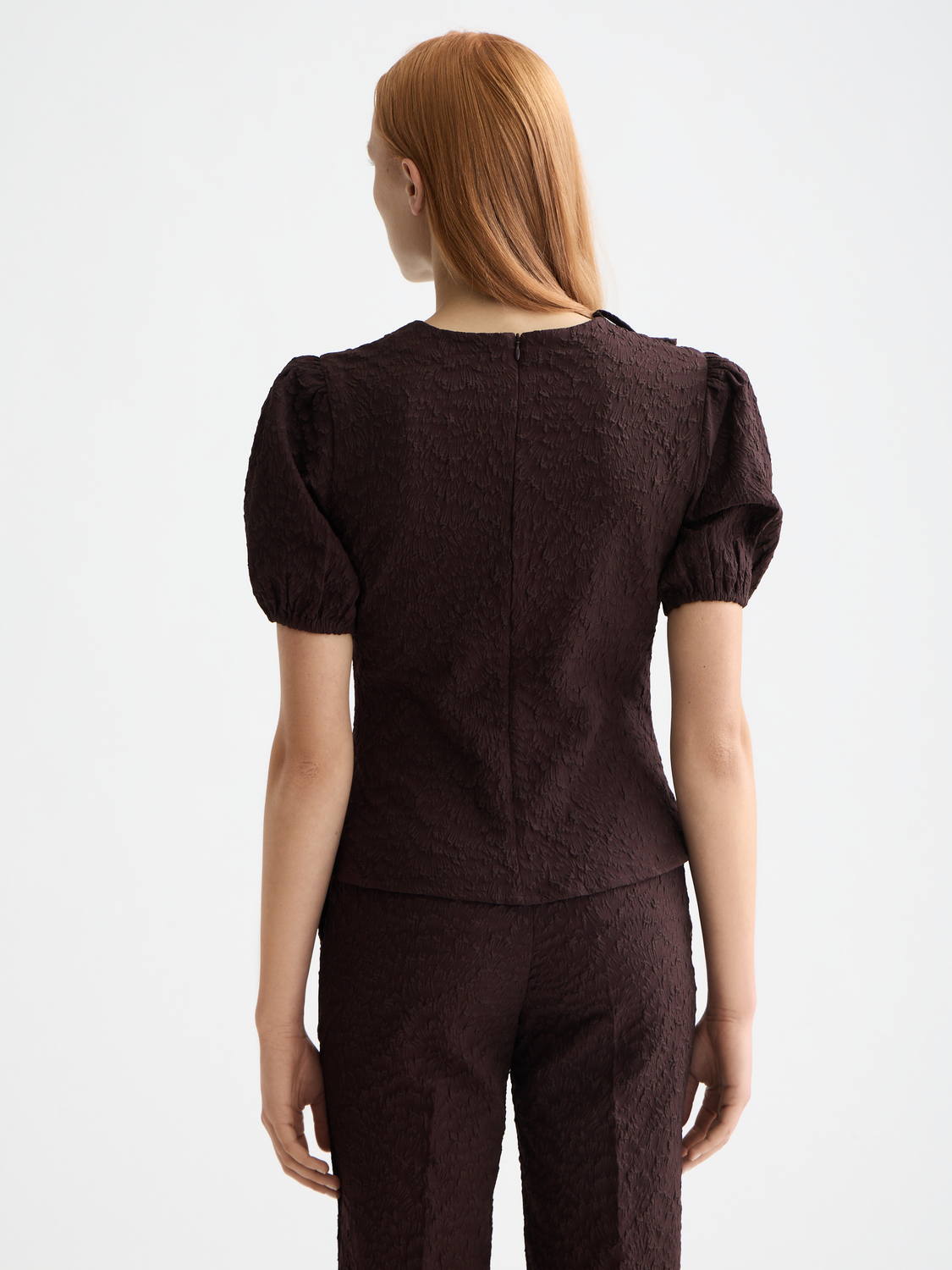 Textured puff sleeve woven top by Scotch & Soda, showcasing a stylish design with ruffled details and a back view.