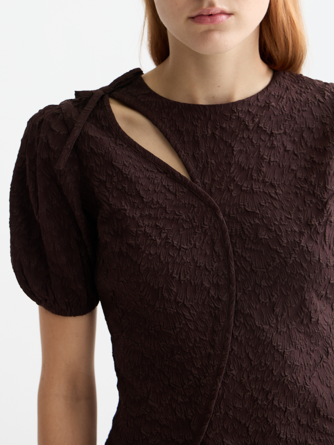 Textured woven top with puff sleeves in a stylish design by Scotch & Soda, shown on a model.