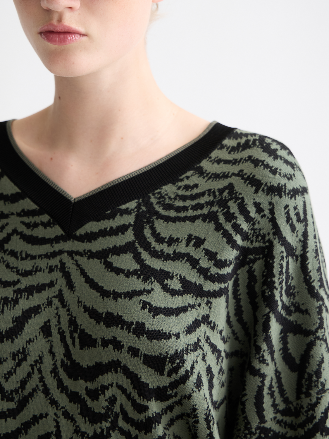 Scotch & Soda jacquard v-neck knitwear pullover with intricate pattern, close-up of the textured fabric and detailed design.