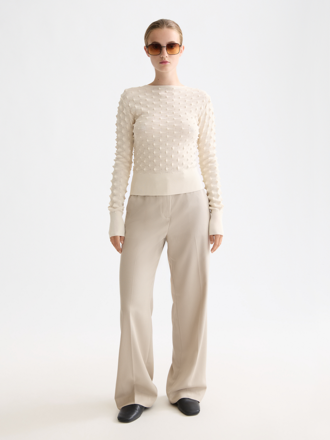 Textured stitch knitwear pullover by Scotch & Soda, showcasing its detailed knit pattern and cozy fit in a casual setting.