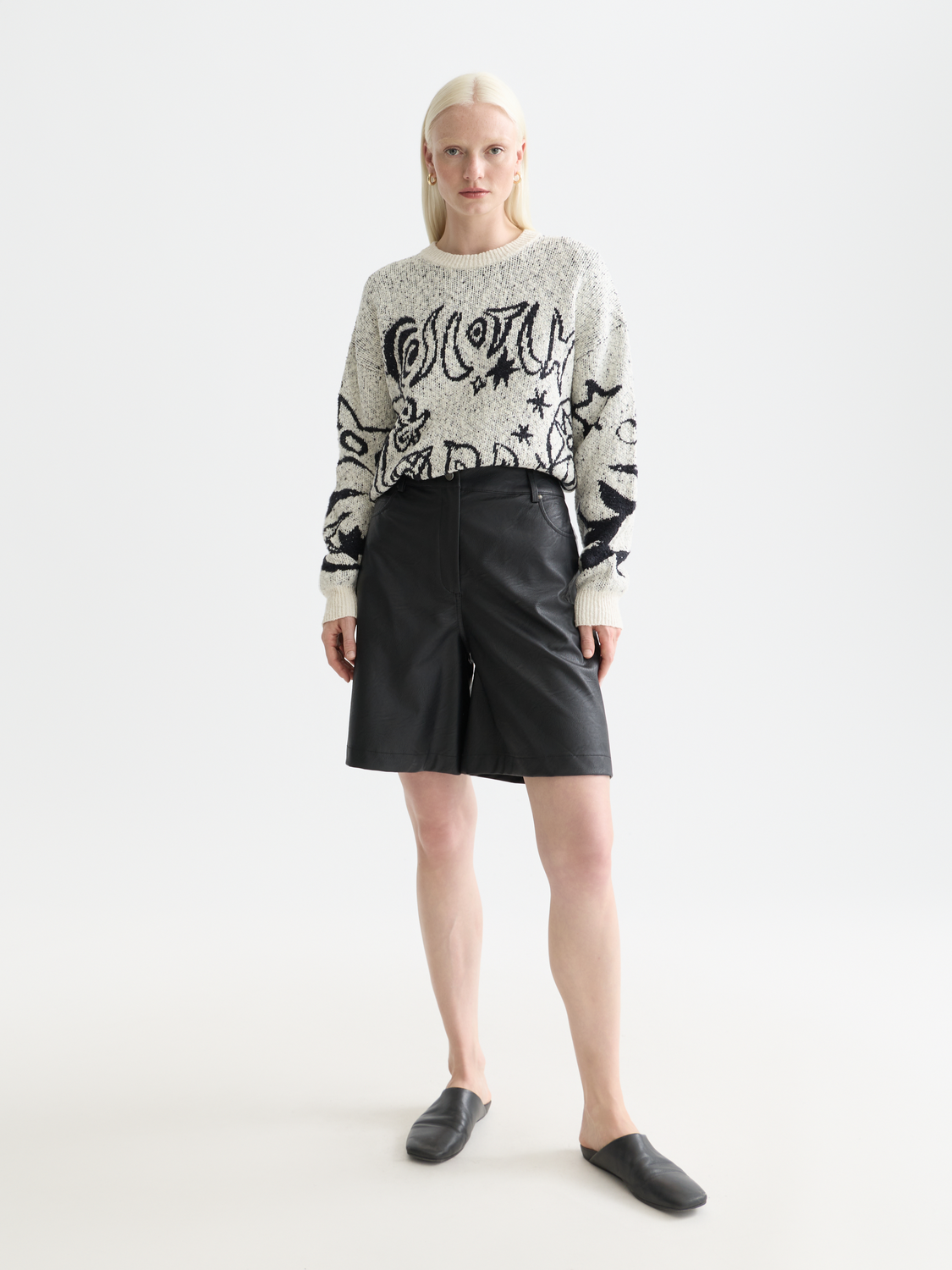 Scotch & Soda jacquard knit pullover featuring intricate patterns in soft, cozy fabric, worn by a model.