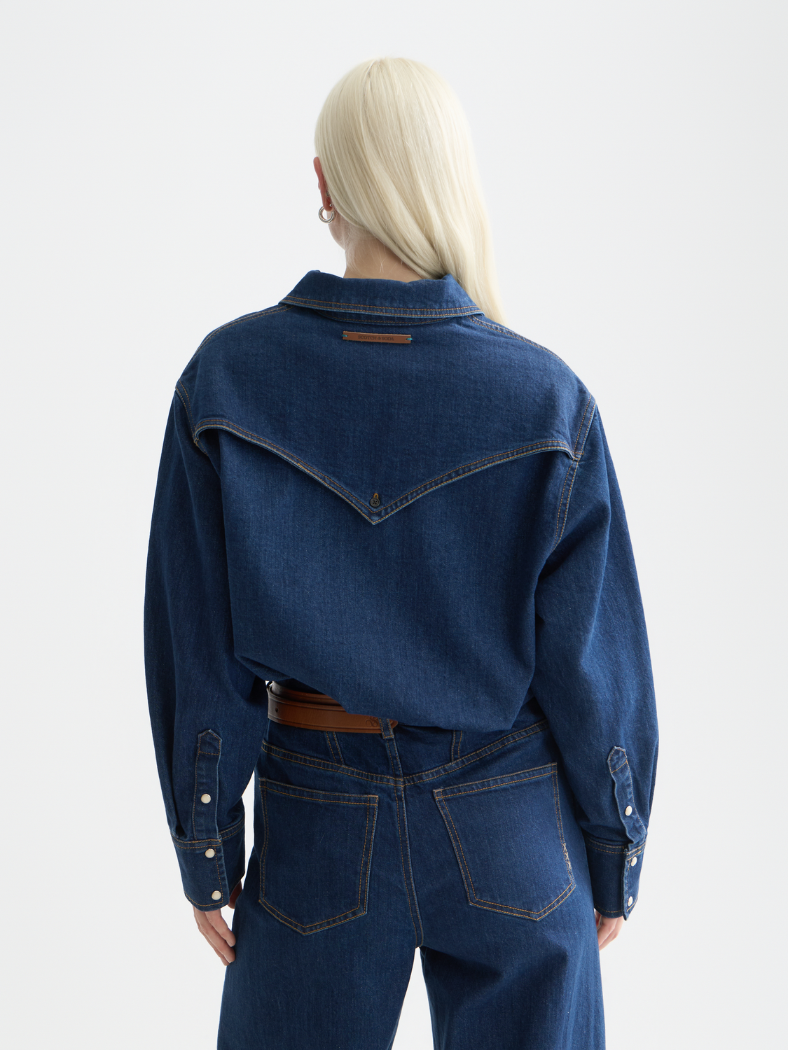 Long-sleeve denim shirt by Scotch & Soda, shown from the back with a classic fit and detailed stitching.