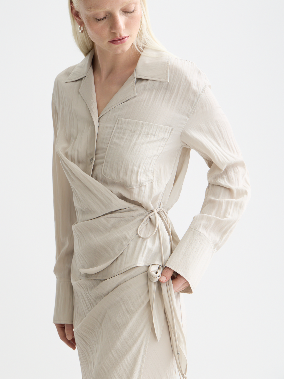 Long sleeve wrap shirt by Scotch & Soda featuring a stylish design, displayed on a model in a well-lit setting.