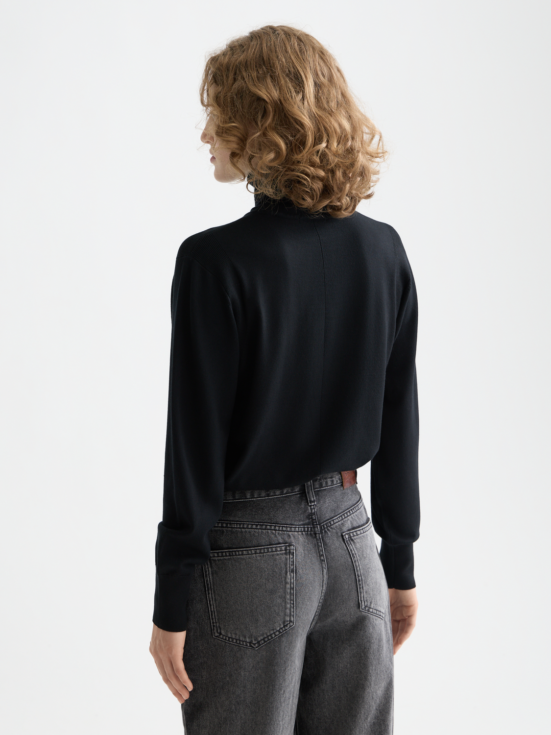 Relaxed navy knitwear with a roll neck from Scotch & Soda, shown from the back, showcasing comfortable, casual style.