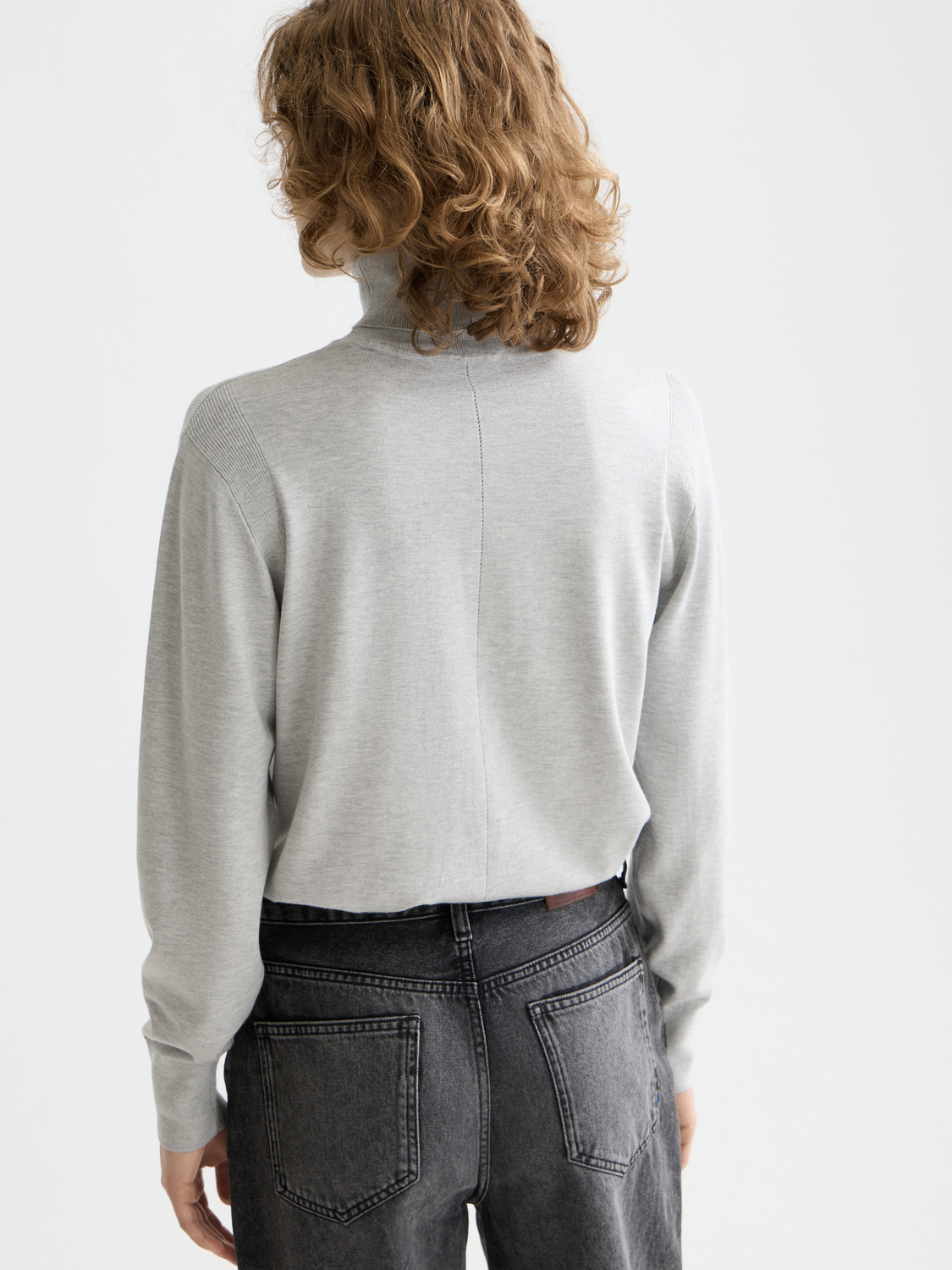 Relaxed knitwear pullover with a roll neck from Scotch & Soda, shown from the back in a cozy, casual style.
