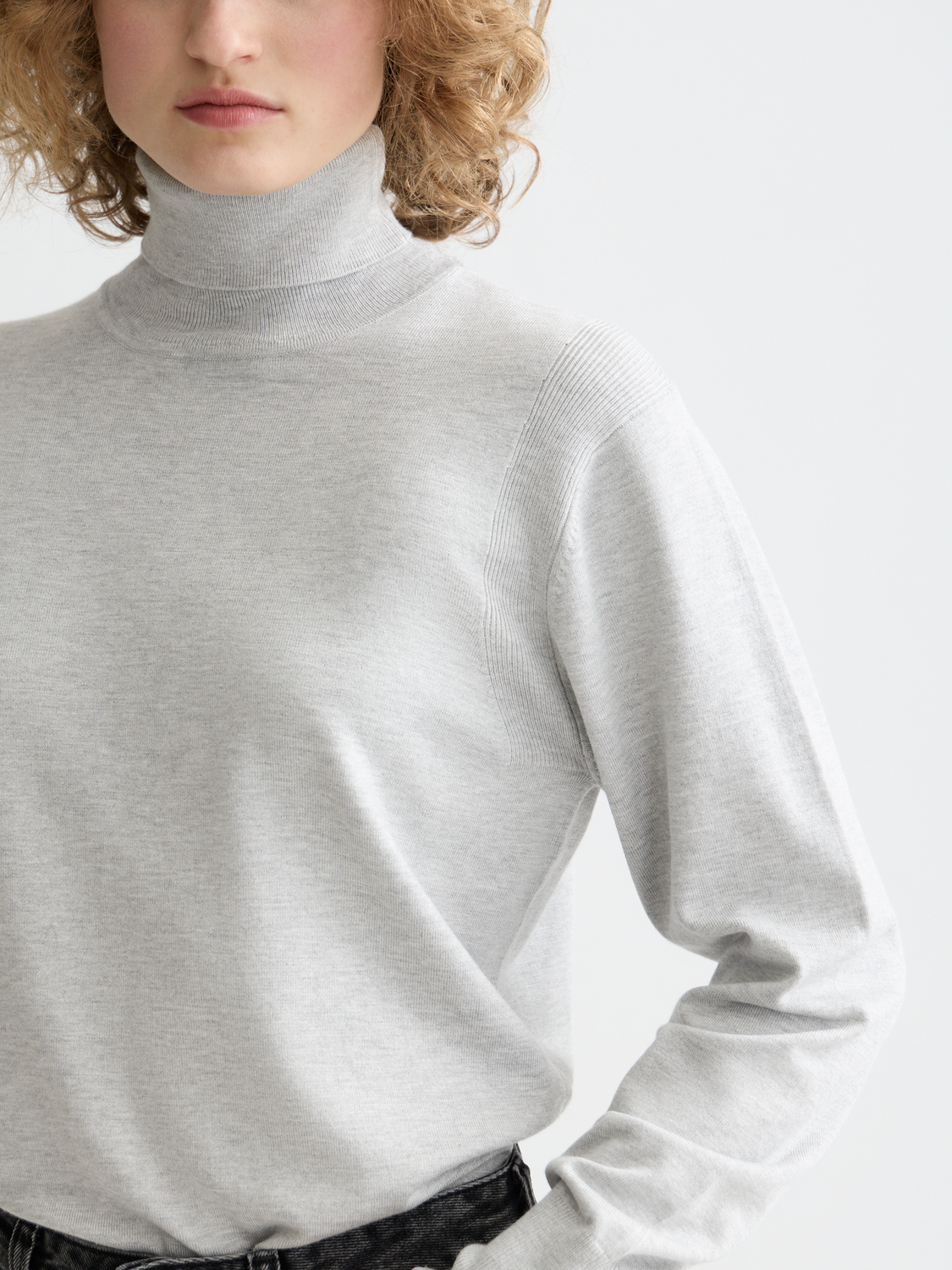 Relaxed knitwear roll neck pullover by Scotch & Soda, featuring soft fabric and a comfortable fit, shown on a model.