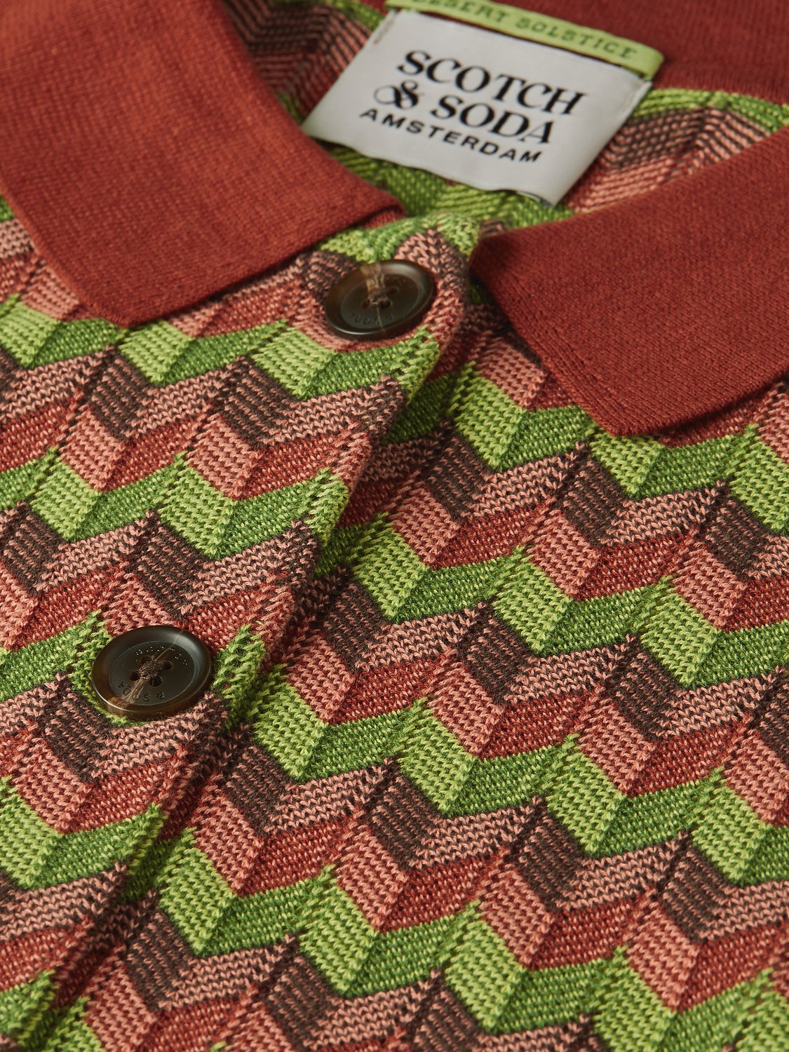 Scotch & Soda jacquard knitted jacket featuring intricate patterns and a cozy knitwear design, displayed on a neutral background.