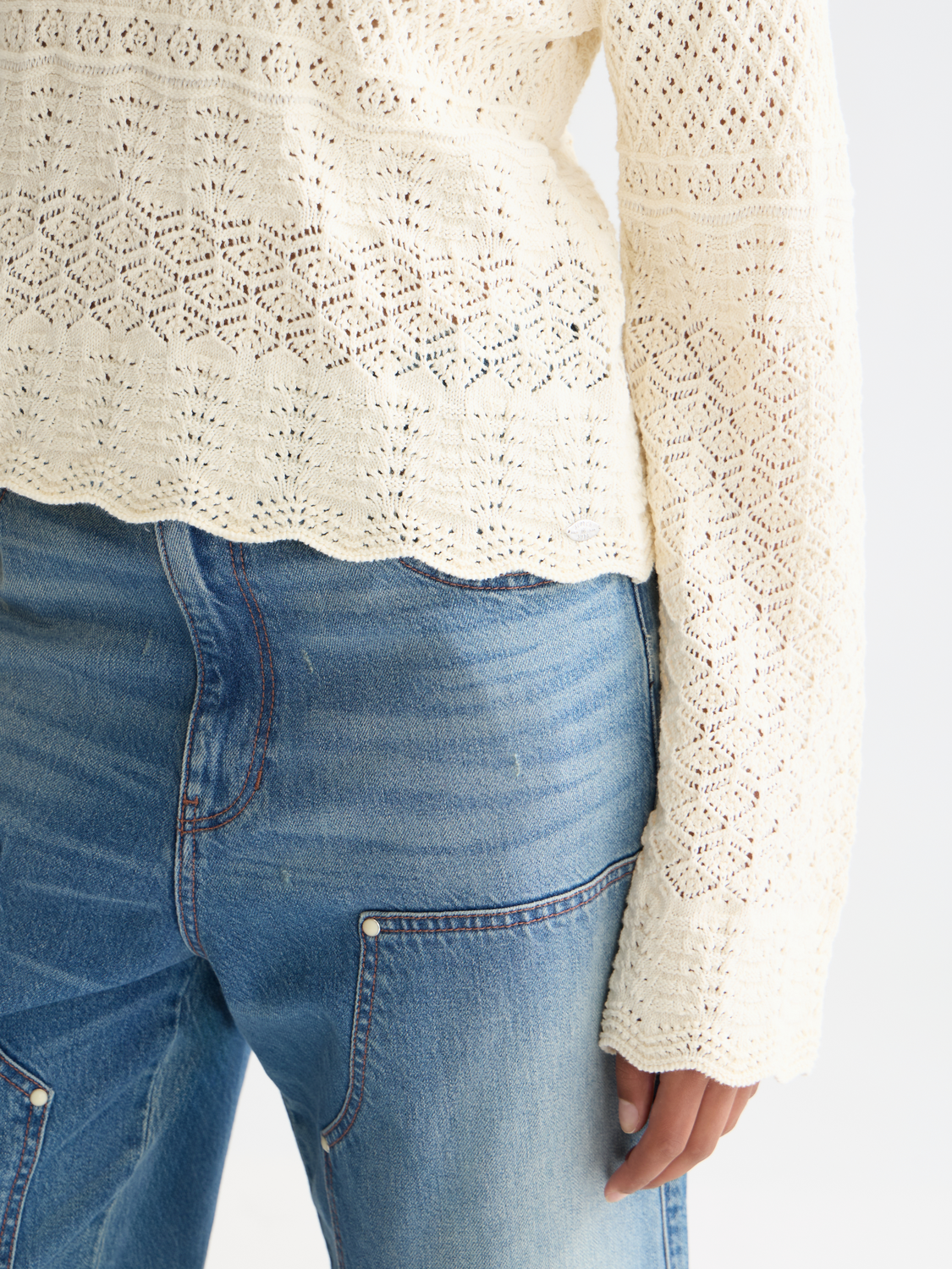 Pointelle V-neck knitwear pullover by Scotch & Soda, showcasing a soft, textured fabric with a V-neckline and delicate pattern.