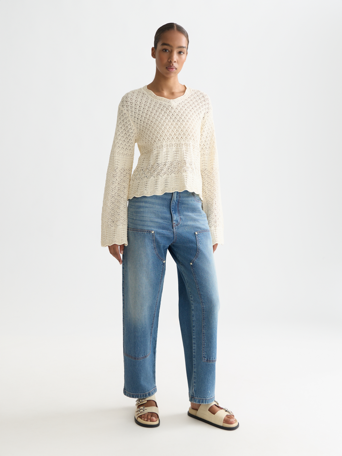 Pointelle v-neck knitwear pullover by Scotch & Soda, featuring a delicate pattern and soft fabric in a close-up view.
