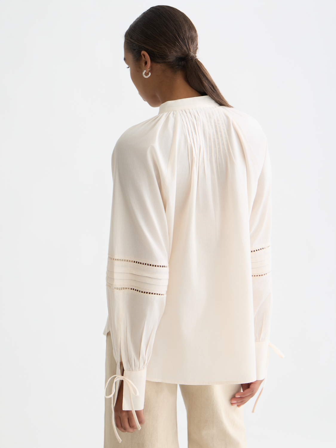Scarlet woven blouse with pleated front and long sleeves, stylishly displayed from the back by Scotch & Soda