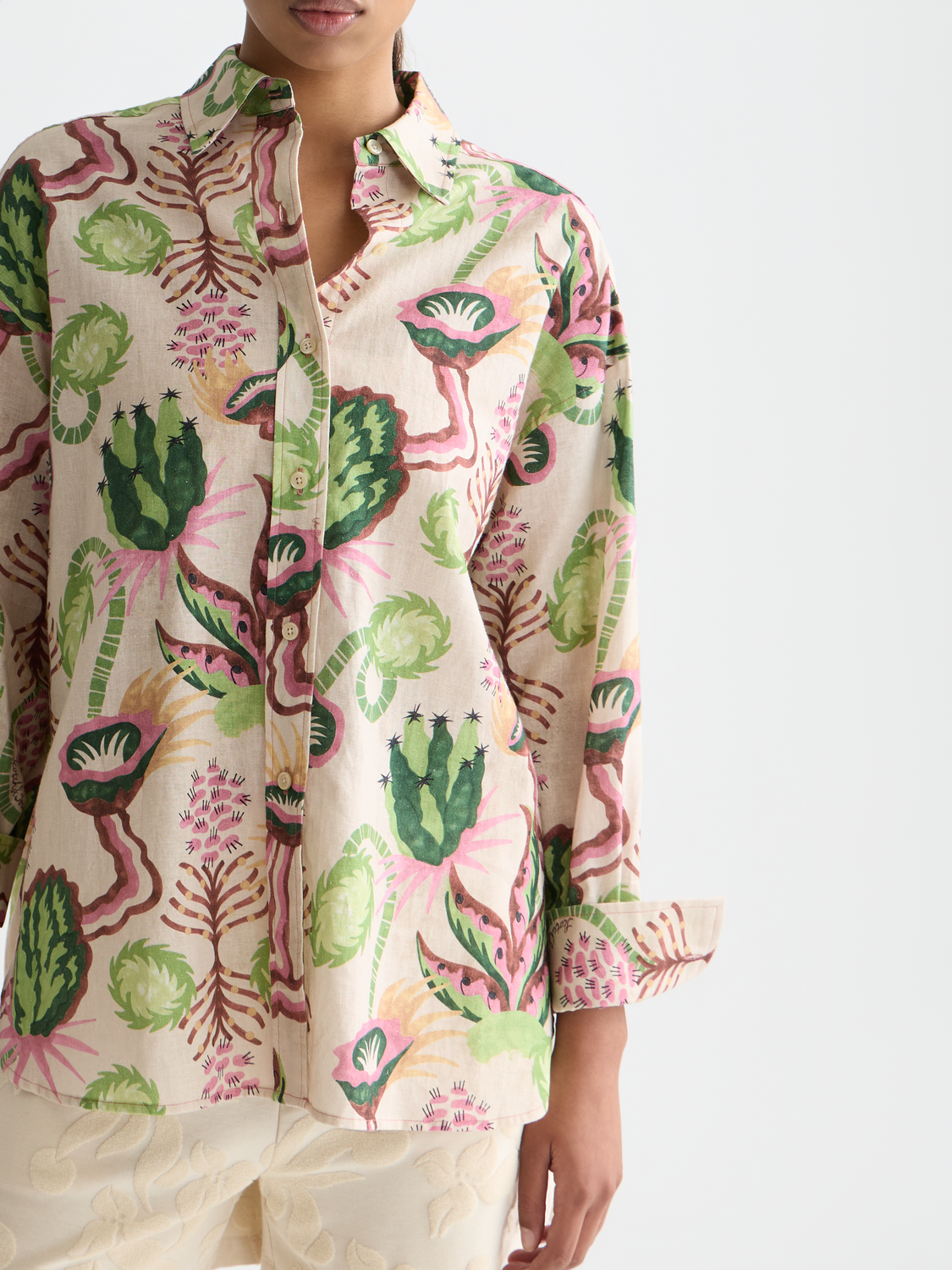 Long-sleeve printed shirt by Scotch & Soda, featuring vibrant patterns and a classic fit, displayed on a hanger.