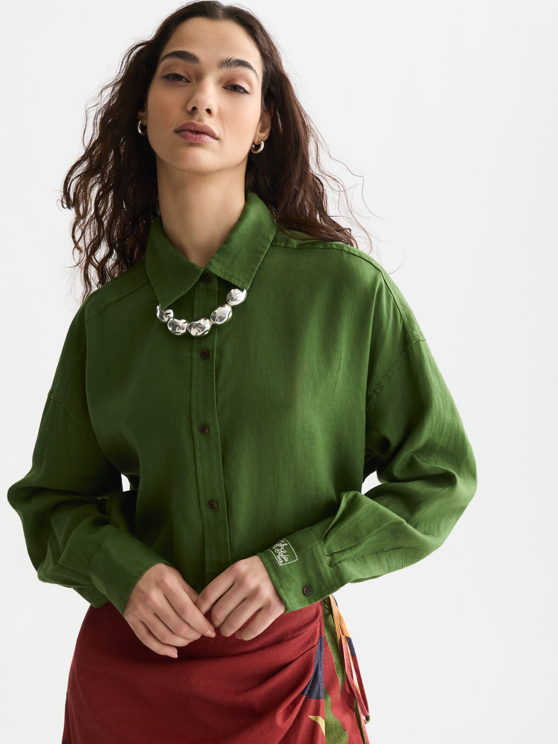 Long-sleeve linen shirt by Scotch & Soda featuring a relaxed fit and natural fabric in a neutral color, shown on a model.
