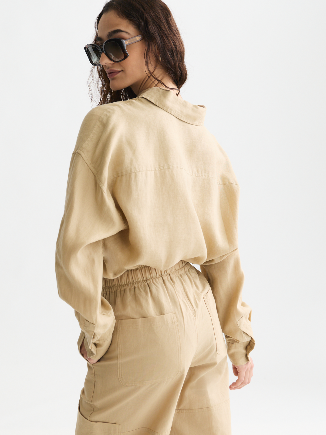 Long sleeve linen shirt by Scotch & Soda, showing the back view with a relaxed fit and natural fabric texture.