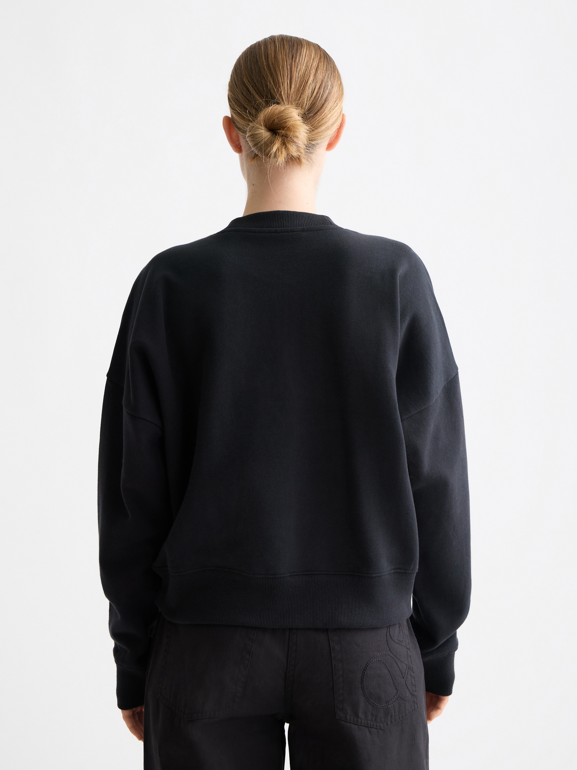 Black sweatshirt with chest artwork featuring Scotch & Soda branding, long sleeves, and a relaxed fit.