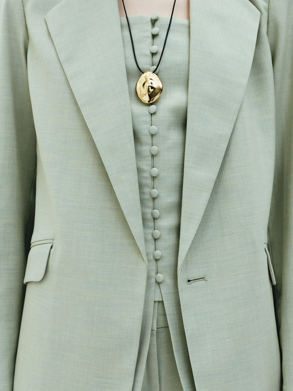 Scotch & Soda belted blazer in neutral fabric with notch lapels and stylish belt, tailored fit, on a hanger.
