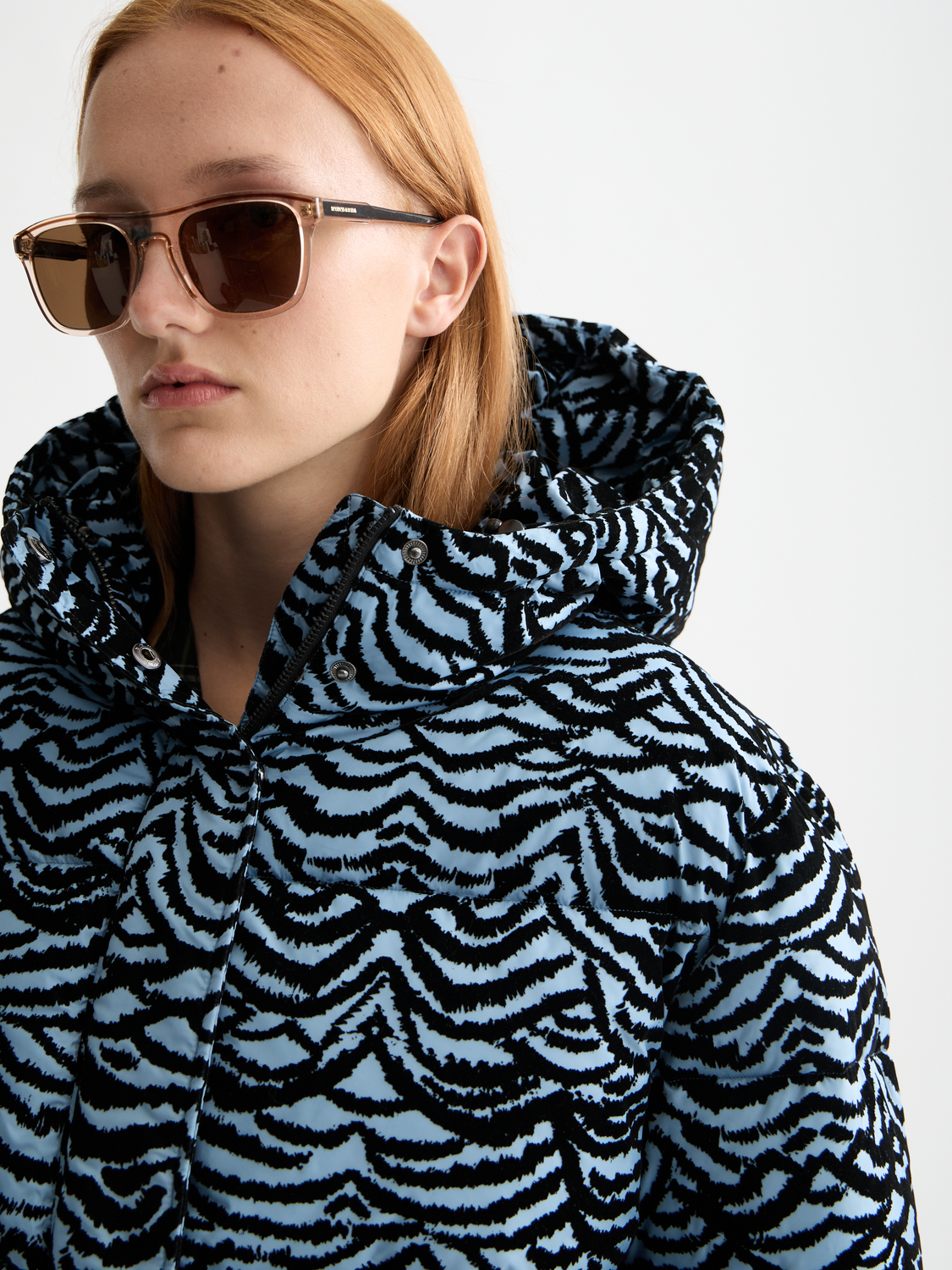 Scotch & Soda hooded puffer jacket with quilted design and front zipper, shown in a neutral color.