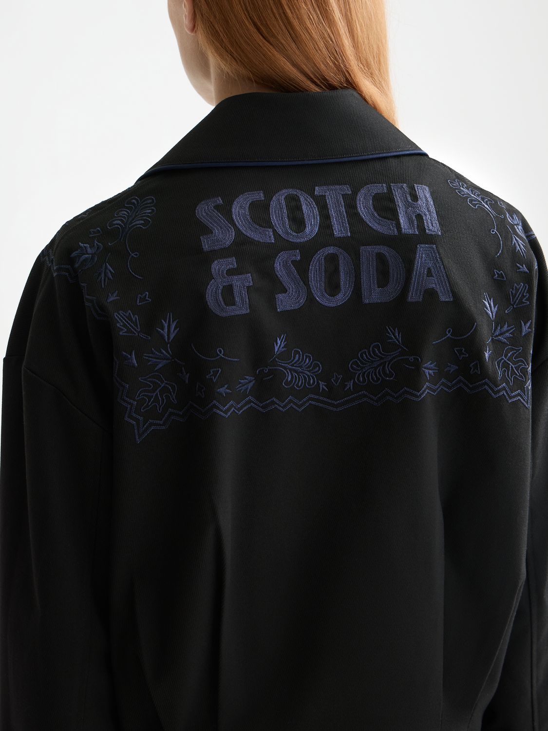 Embroidered Scotch & Soda bomber jacket with detailed stitching, ribbed cuffs, and stylish design, displayed on a model.