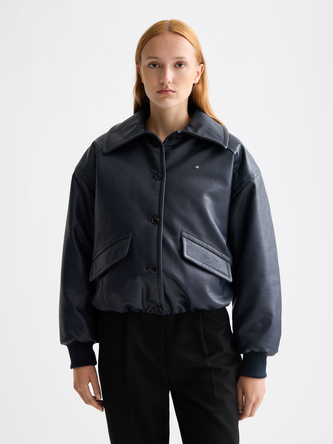 Faux leather bomber jacket by Scotch & Soda featuring a front zipper, ribbed cuffs, and a stylish collar.
