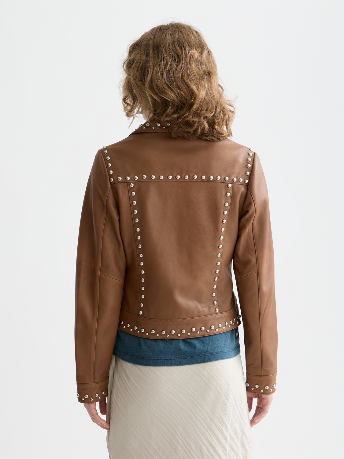 Leather trucker jacket from Scotch & Soda with classic collar, front button closure, and side pockets, shown from the back view.