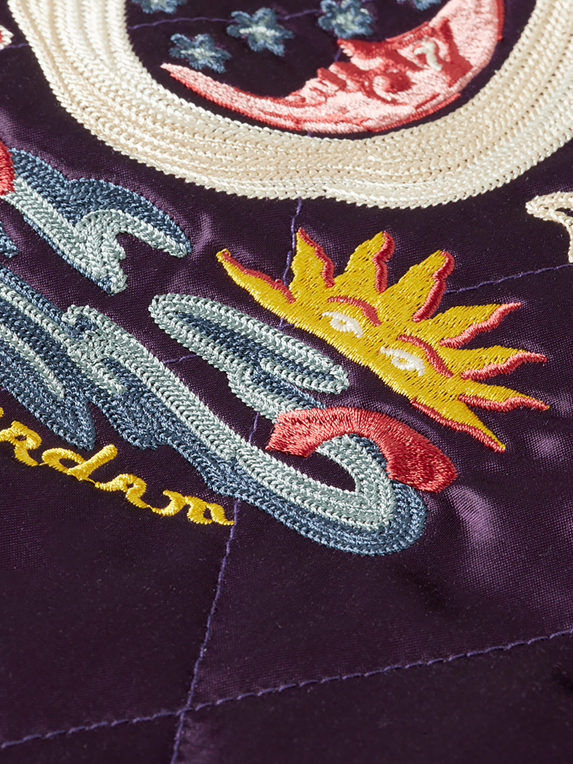 Reversible souvenir jacket by Scotch & Soda featuring bold patterns and vibrant colors, displayed hanging on a wooden hanger.