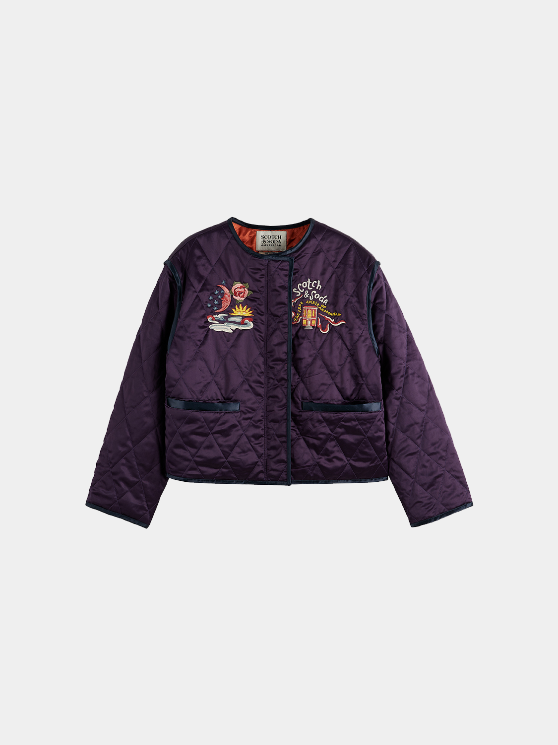 Reversible souvenir jacket by Scotch & Soda showing vibrant, patterned design on one side and solid color on the other.