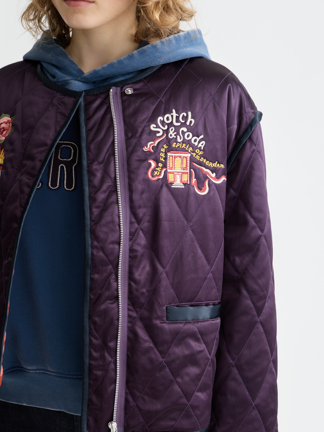 Reversible souvenir jacket by Scotch & Soda featuring bold patterns and vibrant colors, shown with one side displaying intricate design.