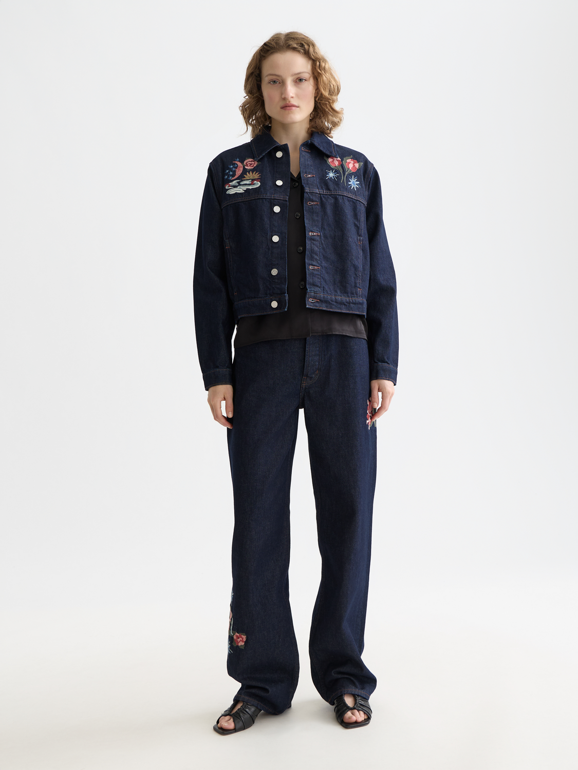 Embroidered denim jacket by Scotch & Soda featuring detailed floral embroidery on front and classic blue denim fabric.