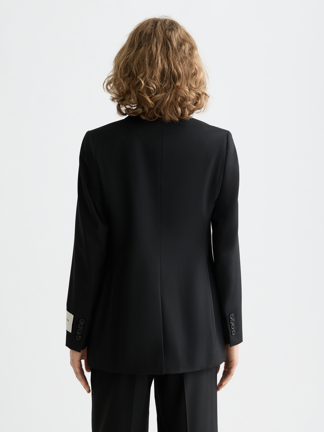Fitted single-breasted blazer from Scotch & Soda, tailored with a structured fit and classic lapel, shown from the back.