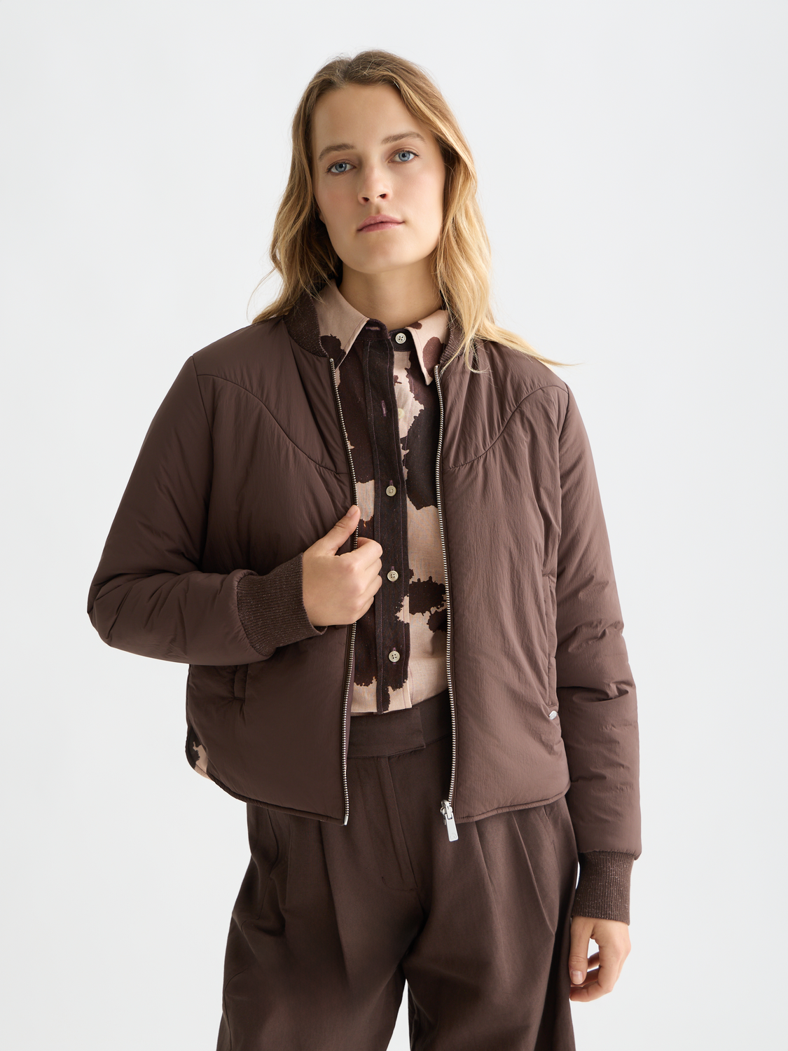 Reversible Scotch & Soda bomber jacket with front zipper, showcasing both patterned and solid fabric sides.