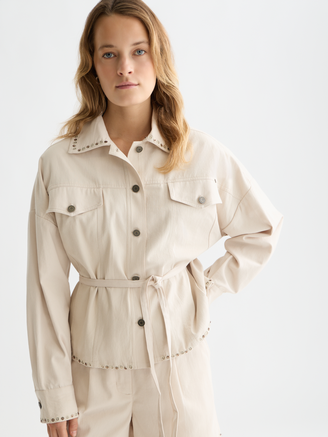 Embellished SCOTCH & SODA trucker jacket with decorative details, front button closure, and classic denim style.