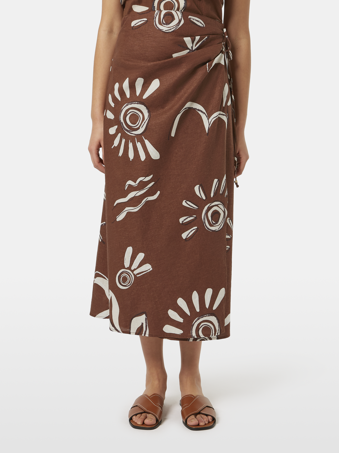 Scotch & Soda midi wrap skirt in floral print, lightweight fabric, shown on a model with a high waist and tied front design.