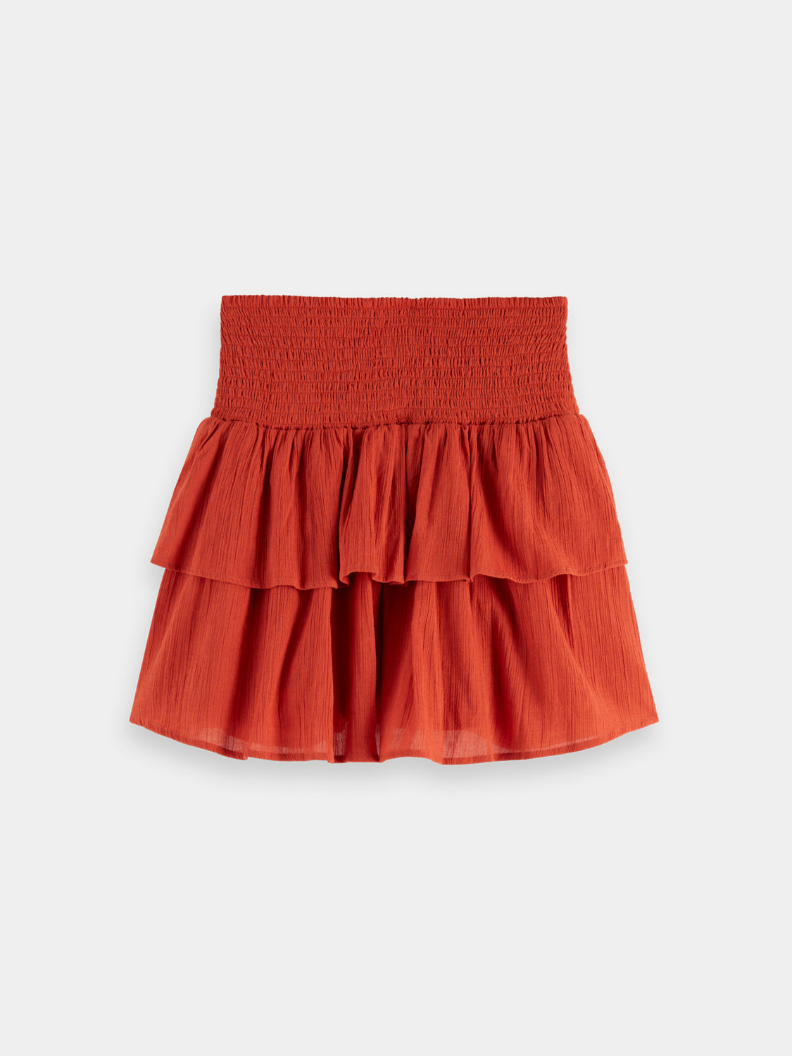 Black smocked mini skirt by SCOTCH & SODA featuring a fitted waist and ruffled hem, displayed on a neutral background.