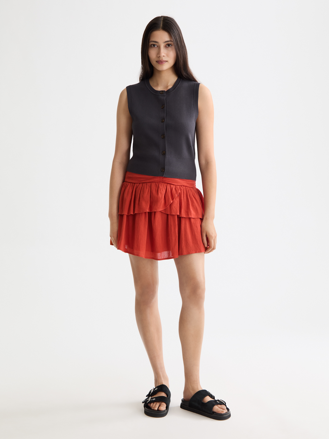 Smocked mini skirt from Scotch & Soda featuring a fitted waist and playful pattern, styled on a model.