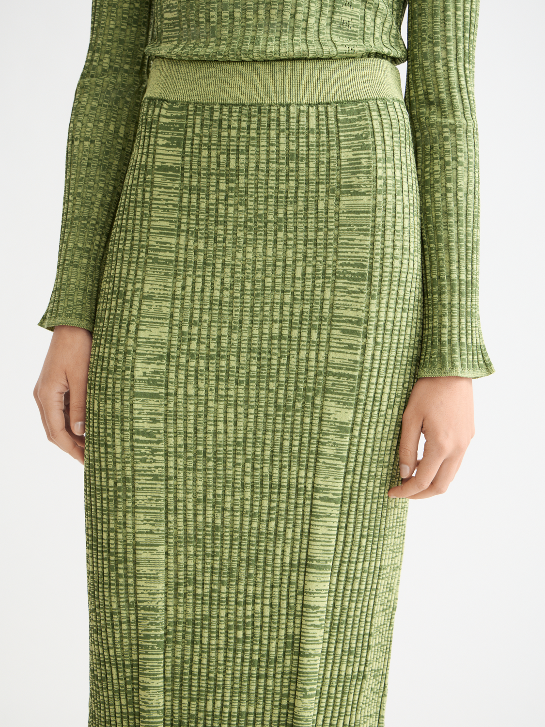 Ribbed knitted maxi skirt by Scotch & Soda featuring a fitted waist and flowing length, styled with neutral tones.