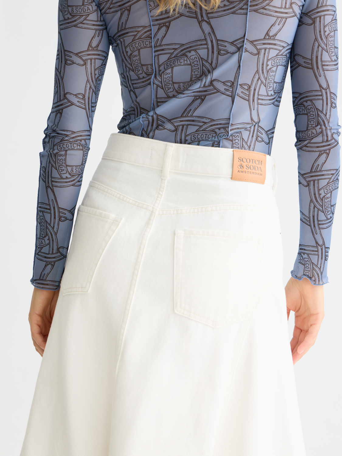 Denim maxi skirt by Scotch & Soda featuring a long flowing design, front pockets, and classic blue denim fabric.