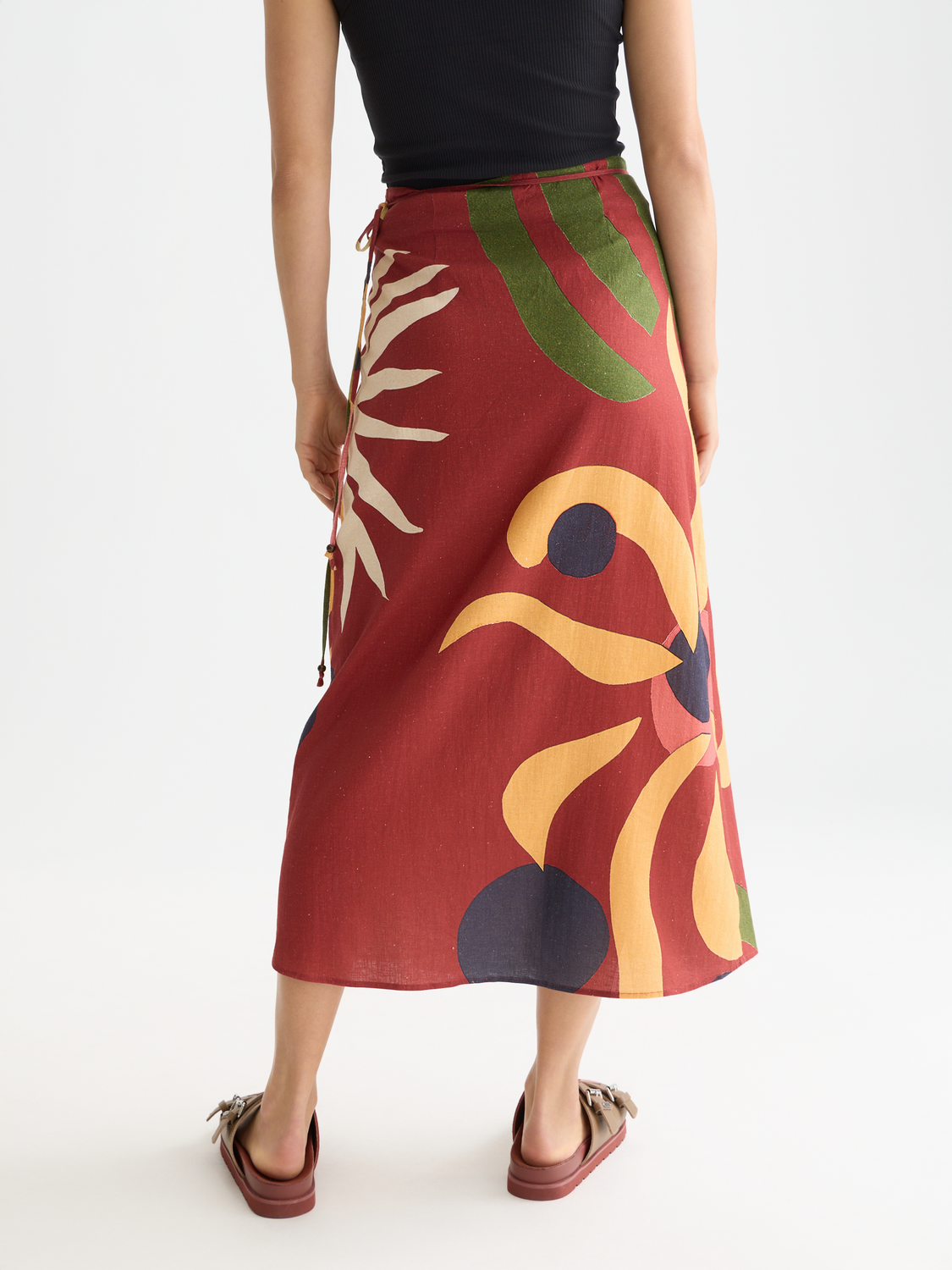 Linen wrap skirt from Scotch & Soda featuring a tied waist and flowing design, back view showing soft, lightweight fabric.