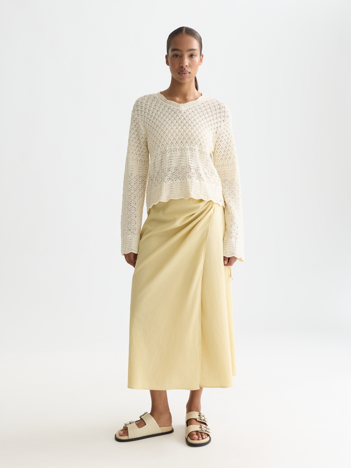 Light beige linen wrap skirt by Scotch & Soda featuring a tied waist and flowing fabric, perfect for casual or summer wear.