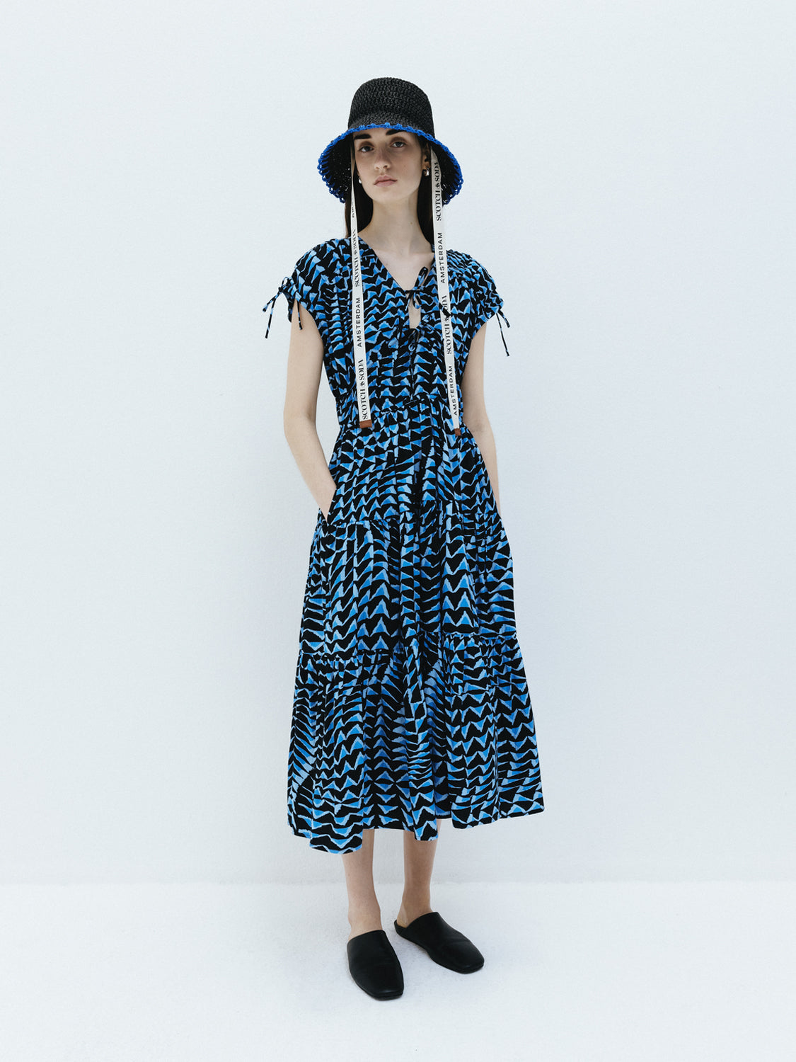 SCOTCH & SODA tiered poplin midi dress displayed on a hanger with a floral pattern and flowing silhouette.