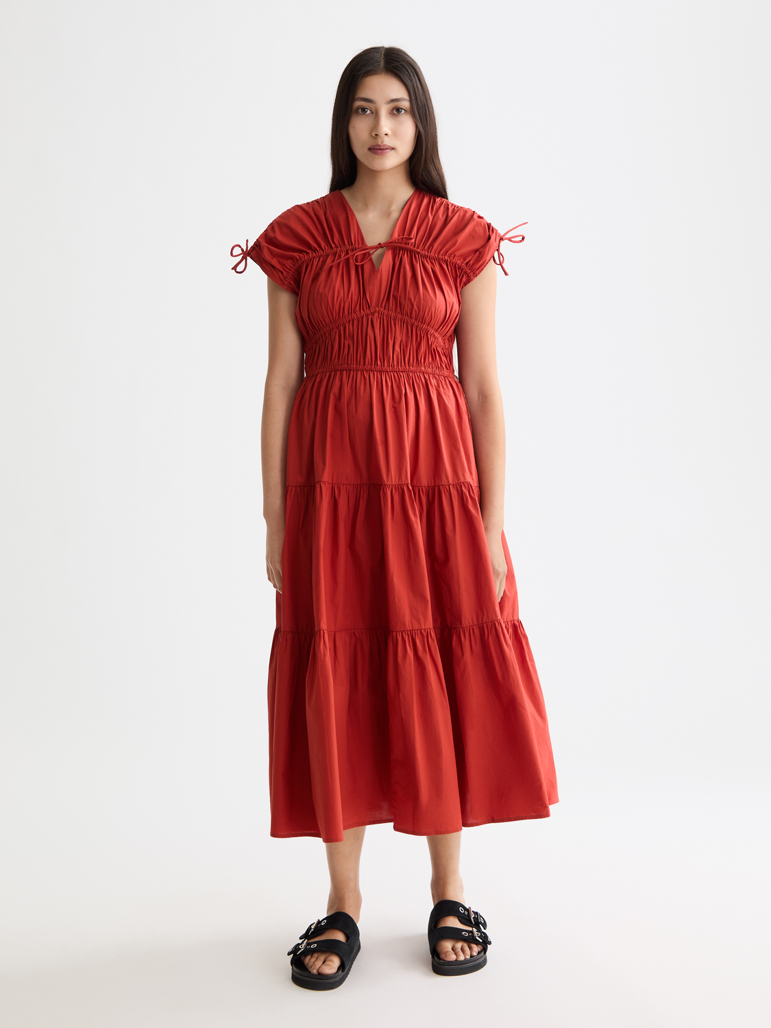 Scotch & Soda gathered midi dress with a flowing silhouette and subtle pattern, displayed on a hanger against a neutral background.