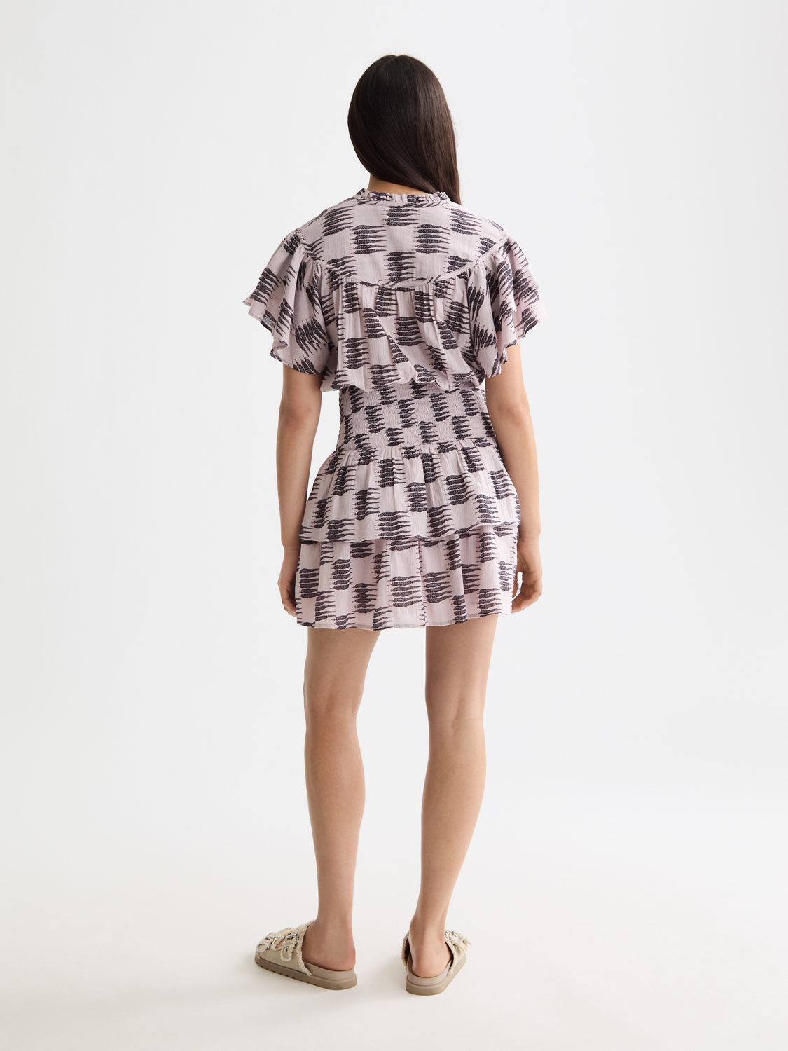 Black ruffled mini dress by Scotch & Soda, featuring fluttering ruffles and a feminine silhouette, perfect for casual or dressy occasions.